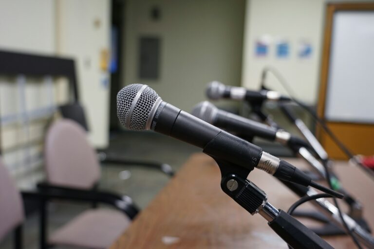 Microphones set up on a press conference table