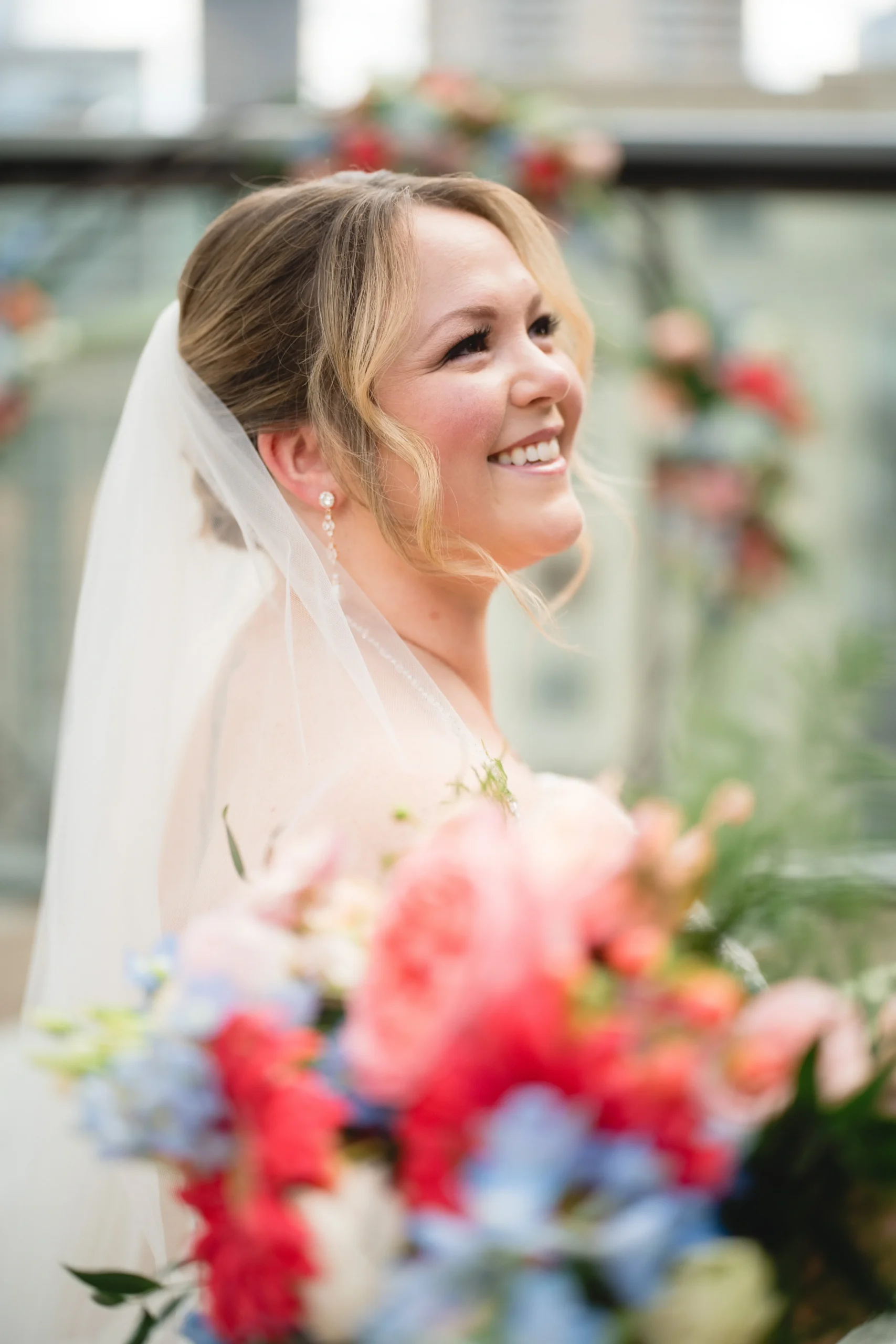 Dr. Courtney Kalmanson smiling and holding a bouquet of flowers